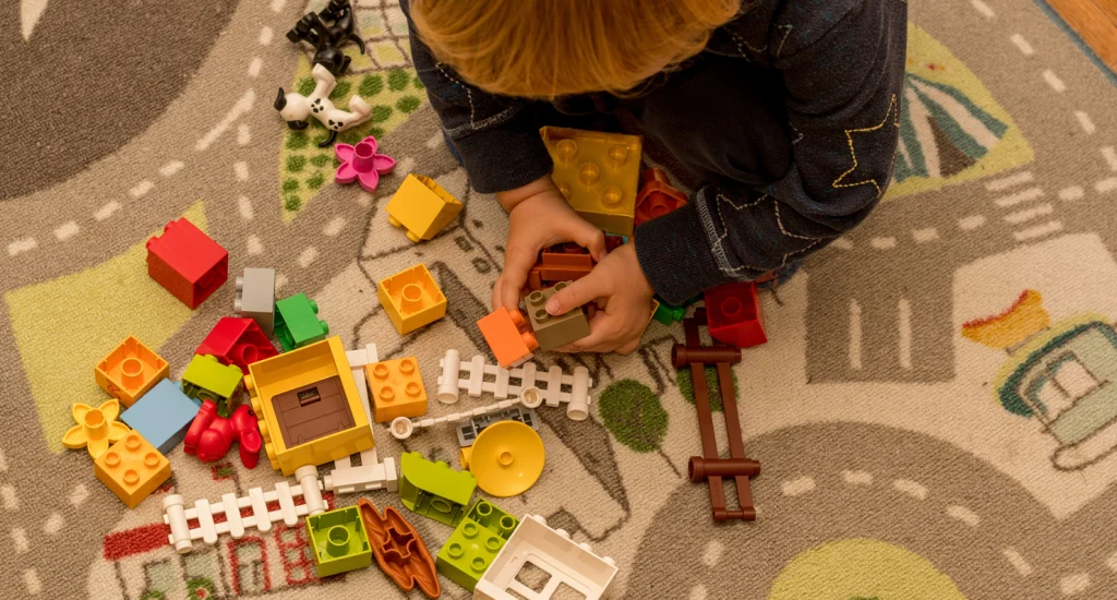 toddler-boy-playing-with-construction-blocks-earl-2022-11-15-14-05-41-utc